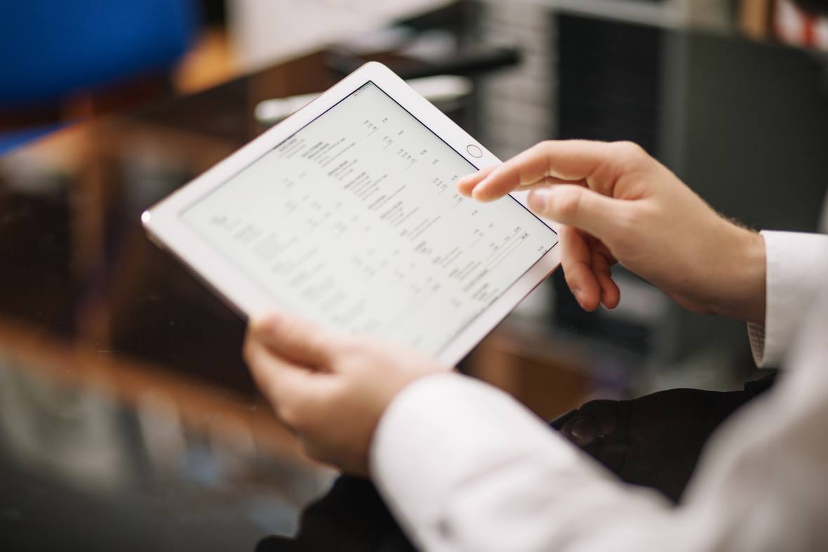 Manager reviewing an itemised report on a tablet