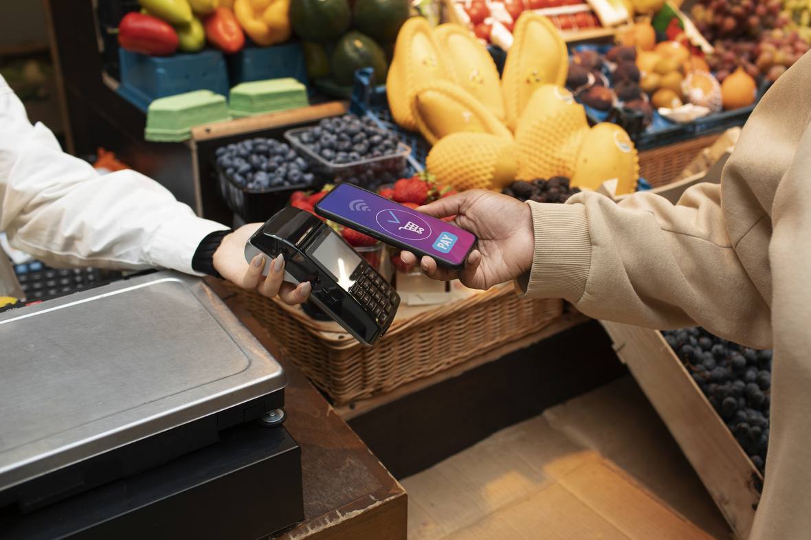 Customer paying by phone at a counter terminal