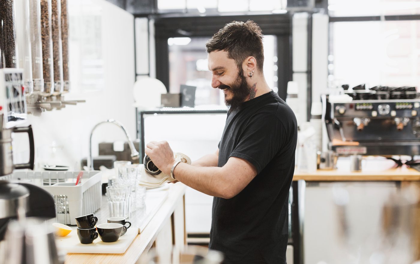Barista working behind the counter of a speciality coffee shop